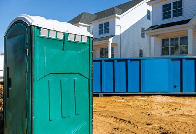 a row of portable toilets located at a busy job site