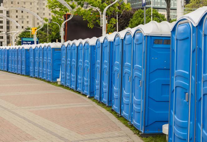 a row of portable restrooms at an outdoor special event, ready for use in Ypsilanti MI